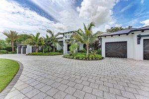 A home with a driveway and palm trees, perfect for those seeking a peaceful oasis.