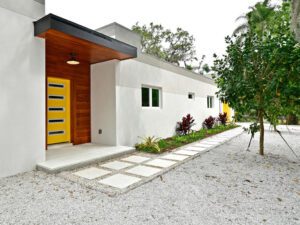 A residential house with a yellow door.